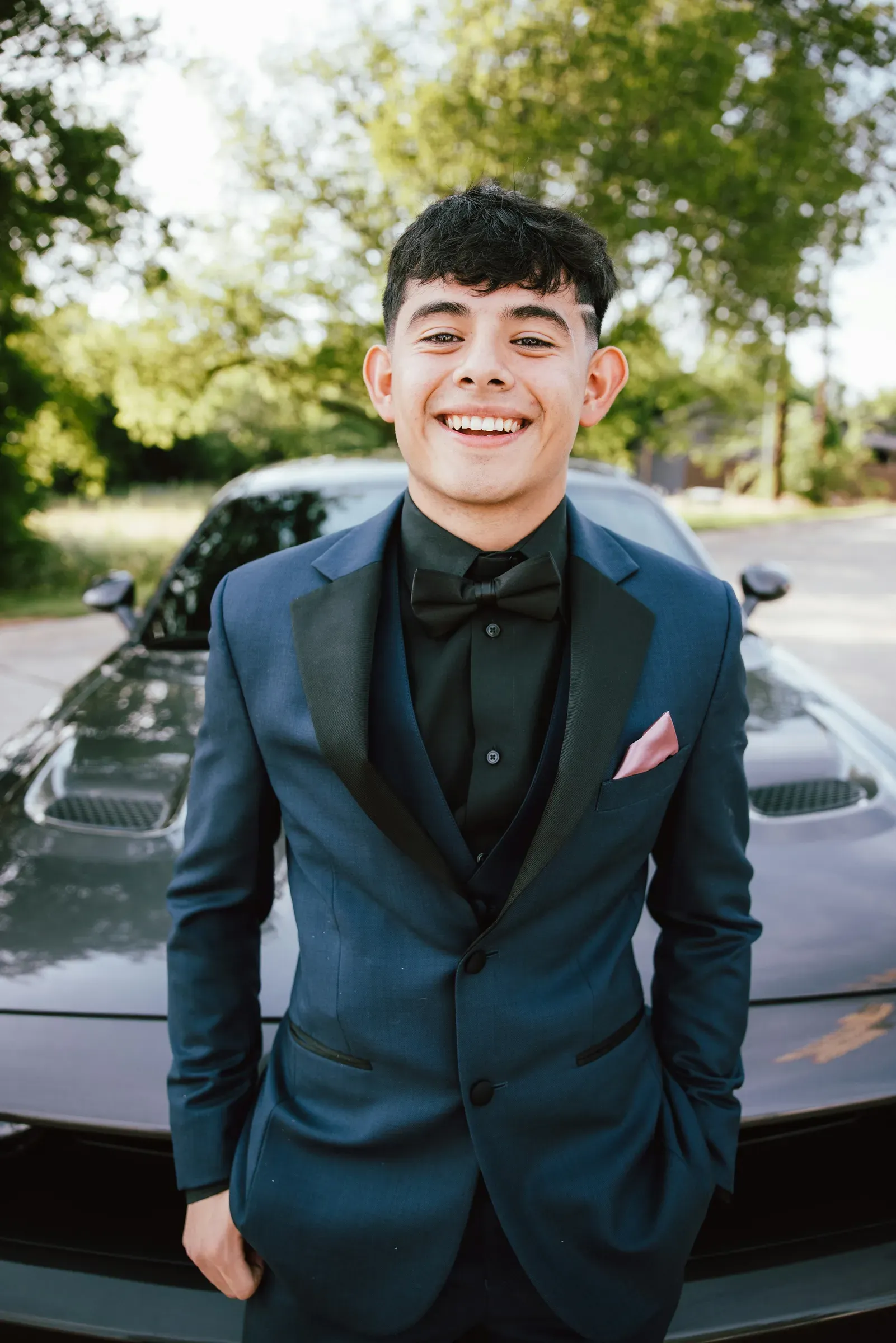 Navy tux, pink pocket square, and his dad's car for the night.