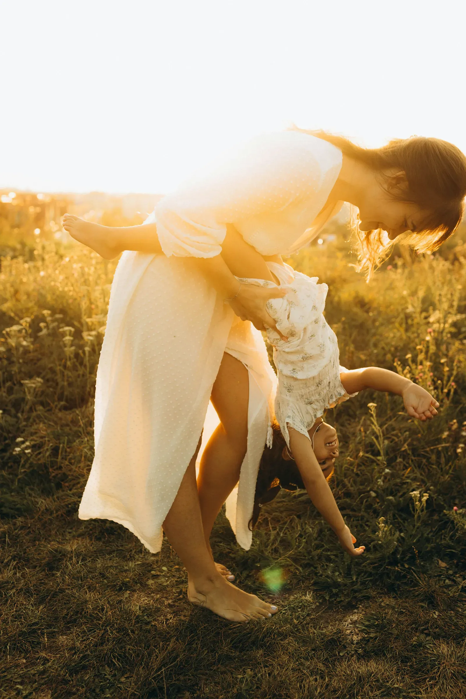Mother and daughter backlit and blown out in the best way, right at sundown.