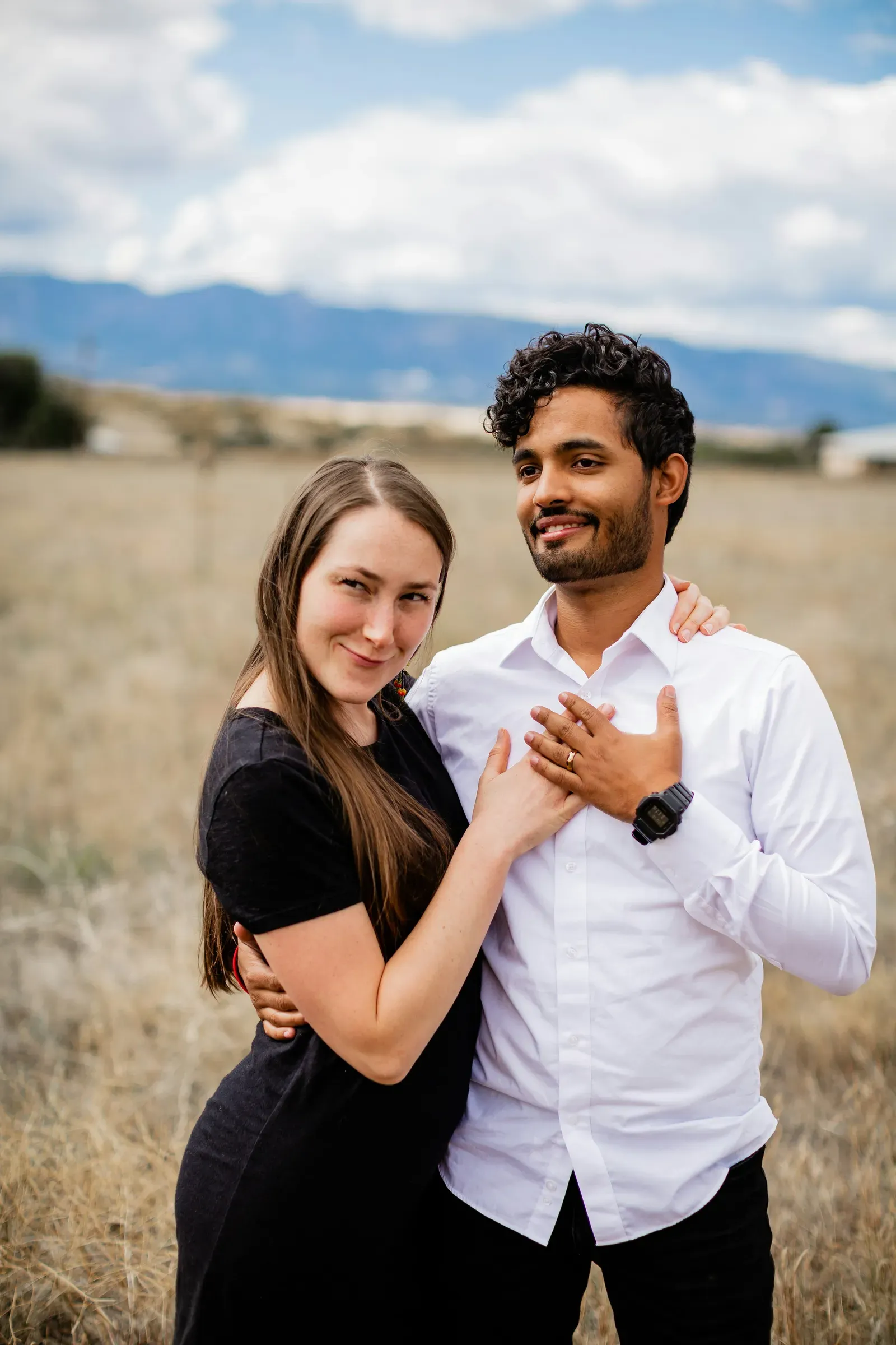 Her ring hand flat on his chest, both of them looking right into the lens.